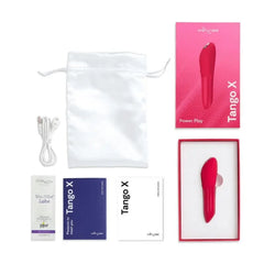 Tango X unboxed showing vibrator, satin pouch, USB cable, lube sample, and manual