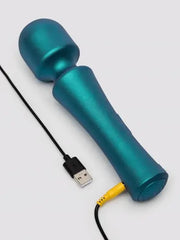 Teal ROMP Presto Wand lying flat beside USB charging cable with yellow connector