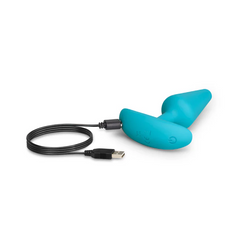 Teal silicone vibrating plug connected to USB magnetic charging cable for recharging