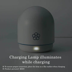 Temari vibrator in charging base with illuminated indicator light showing active USB charge status