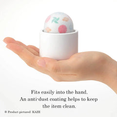 Temari vibrator resting in palm, compact size with anti-dust coated soft-touch surface