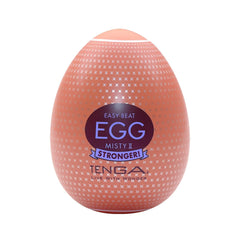 Tenga Egg Misty II Hard Boiled masturbator in coral egg-shaped shell with cross-pattern texture