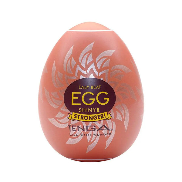 Tenga Egg Shiny II hard boiled masturbator in orange egg-shaped shell with silver leaf design
