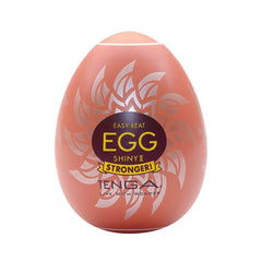 Tenga Egg Shiny II hard boiled masturbator in orange egg-shaped shell with silver leaf design