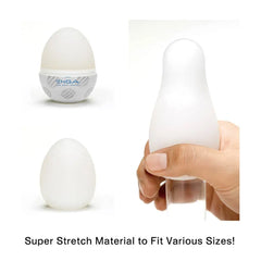 Tenga Egg Sphere shown in packaging, open, and stretched over hand demonstrating super-stretch material