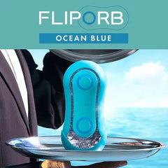 Tenga Flip Orb Ocean Blue displayed on a silver tray with ocean backdrop