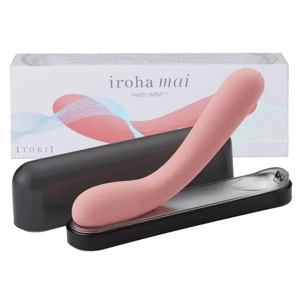 Tenga Iroha Mai Toki vibrator in soft pink beside its wireless charging base and box