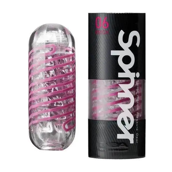 Tenga Spinner Brick stroker with pink spiral coil and black cylindrical packaging beside it