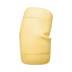 Tenga PUFFY Custard Yellow side angle showing flexible body with ergonomic hand-grip indentation