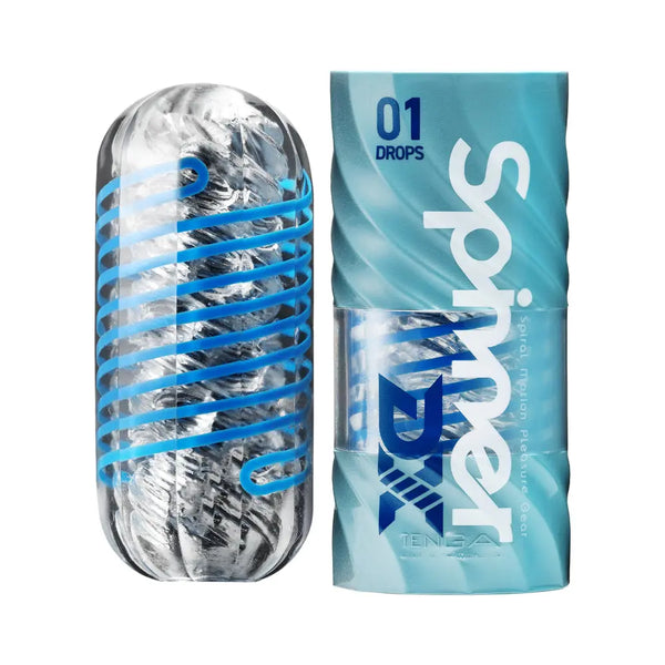 Tenga Spinner DX 01 Drops clear masturbator beside its blue wave-patterned cylindrical packaging