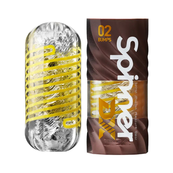Tenga SPINNER DX 02 Bumps clear masturbator with yellow spiral ribs beside brown packaging