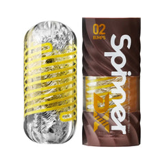 Tenga SPINNER DX 02 Bumps clear masturbator with yellow spiral ribs beside brown packaging