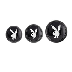 Close-up of three black Playboy Bunny logo base caps in graduated sizes