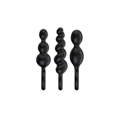 Close-up of three black silicone anal plugs: beaded, spiral, and tapered shapes side by side