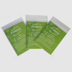 Three individually wrapped Harmony latex dam single-use packets fanned out, green packaging