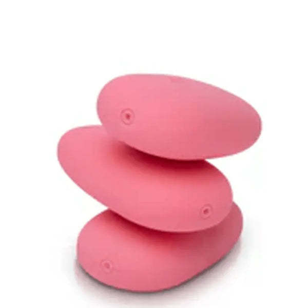 Three pink Je Joue ILY Pebble vibrators stacked like zen stones, showing button
