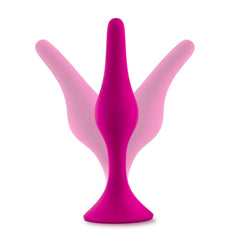 Three pink silicone beginner plugs fanned out to show graduating sizes and tapered tip design