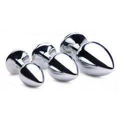 Three polished stainless steel anal plugs in small, medium, and large sizes