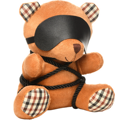 Three-quarter angle of bondage teddy bear with vegan leather blindfold and plaid patterned ears