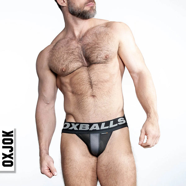 Three-quarter lifestyle view of OXJOK jockstrap on male model, showing waistband width and pouch fit