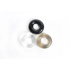 Three TPE stretch rings in black, clear, and smoke tones shown loose on a white background