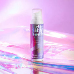 Tickle My Body massage foam bottle on holographic surface with soft pink and purple background