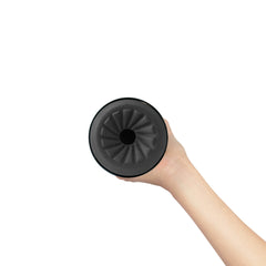 Top-down view of Feel Pocket Stroker entry held in hand, showing spiral ridged silicone opening