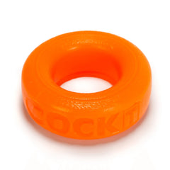 Top-down close-up of orange Oxballs Cock-T ring with embossed lettering on outer band