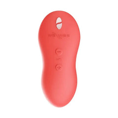Top view of We-Vibe Touch X coral silicone vibrator showing power and intensity control buttons