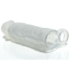 Translucent silicone cock extender lying flat, showing open base ring and realistic shaft texture
