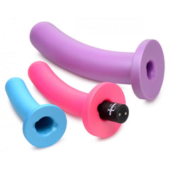 Triple Peg silicone dildos lying flat showing hollow suction bases with inserted bullet vibrator