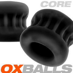 Two black CORE ballstretchers by Oxballs showing ribbed exterior and open center tunnel