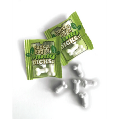 Two green foil candy packets beside loose white mint-flavored novelty-shaped sugar candies
