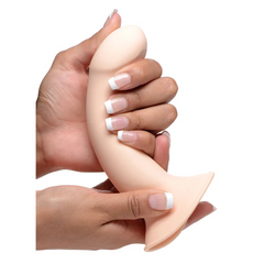 Two hands bending the flexible flesh-tone dildo to demonstrate its squeezable silicone build