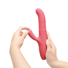 Two hands demonstrating flexible clitoral arm of Le Wand Thrust rabbit vibrator being gently bent