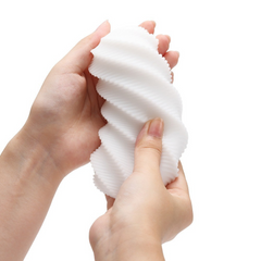 Two hands gently squeezing the flexible white spiral sleeve, showing soft material