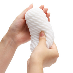 Two hands gently squeezing the Tenga 3DX Flow showing flexible soft material