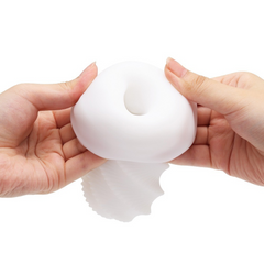 Two hands stretching the open entry of the soft white sleeve to show flexibility