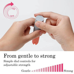 Two hands turning dial on gray base of coral stick vibrator to adjust vibration strength