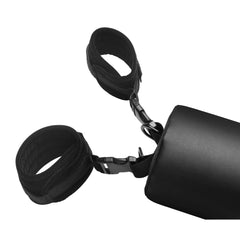Close-up of two padded neoprene wrist cuffs clipped to D-ring at end of black spreader bar
