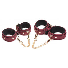 Two pairs of burgundy velvet cuffs connected by adjustable gold-tone chain links