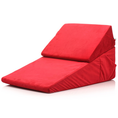 Two red foam wedge cushions joined together showing angled ramp and bolster configuration