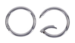 Close-up of two silver O-rings, one open showing spring-latch connection point