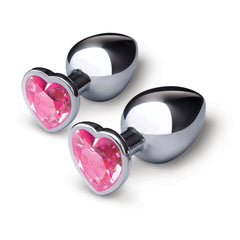 Two silver stainless steel butt plugs with pink heart-shaped jewel bases, side by side