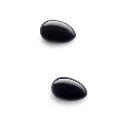 Two smooth polished black obsidian yoni eggs shown separately on white background