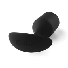 Underside view of b-Vibe Snug Plug 4 showing flat anchor base with embossed brand logo