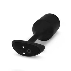 Underside of b-Vibe snug plug base revealing magnetic charging ports and power button