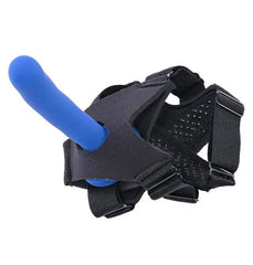 Underside view of black foot strap harness with blue dildo and textured non-slip sole panel