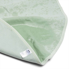 Underside of Dame blanket folded open, exposing waterproof inner lining and care label at corner