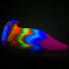 Unicorn Kiss dildo glowing in vibrant rainbow colours in the dark, highlighting glow-in-the-dark feature
